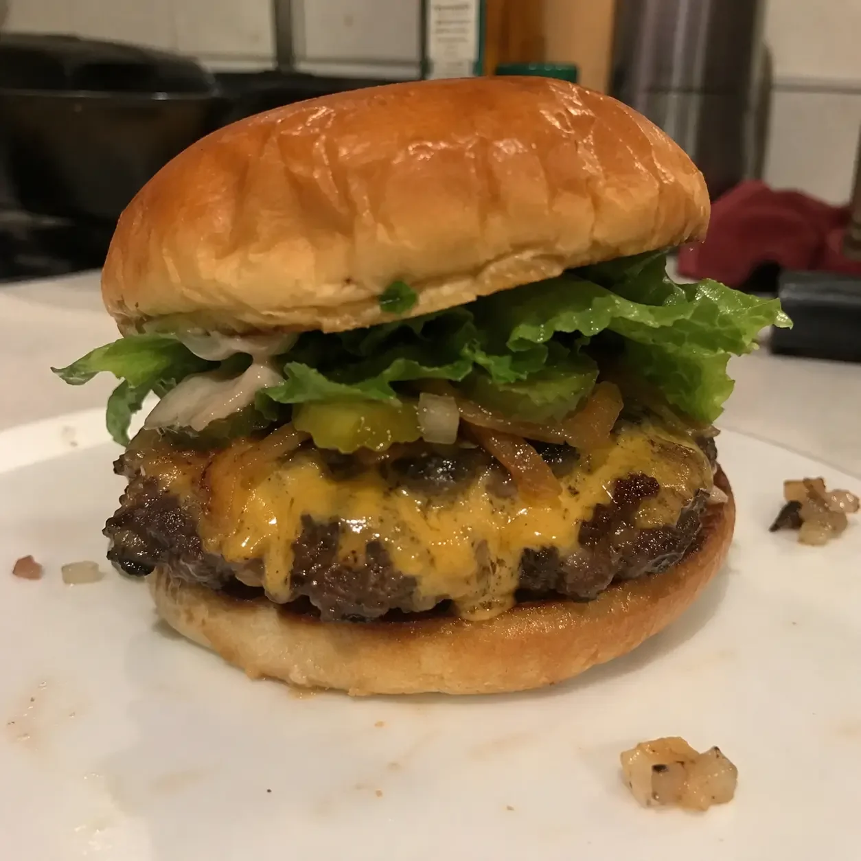 Dim kitchen phone photo of a burger before enhancement for DoorDash